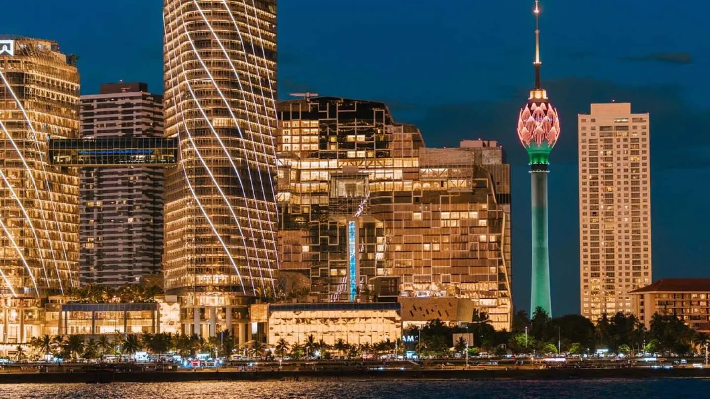 Stunning Colombo city skyline at night with the illuminated Lotus Tower and modern skyscrapers.