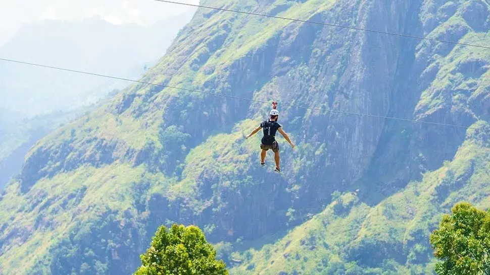 Thrilling zip-lining experience over lush mountains at Ella Adventure Park.