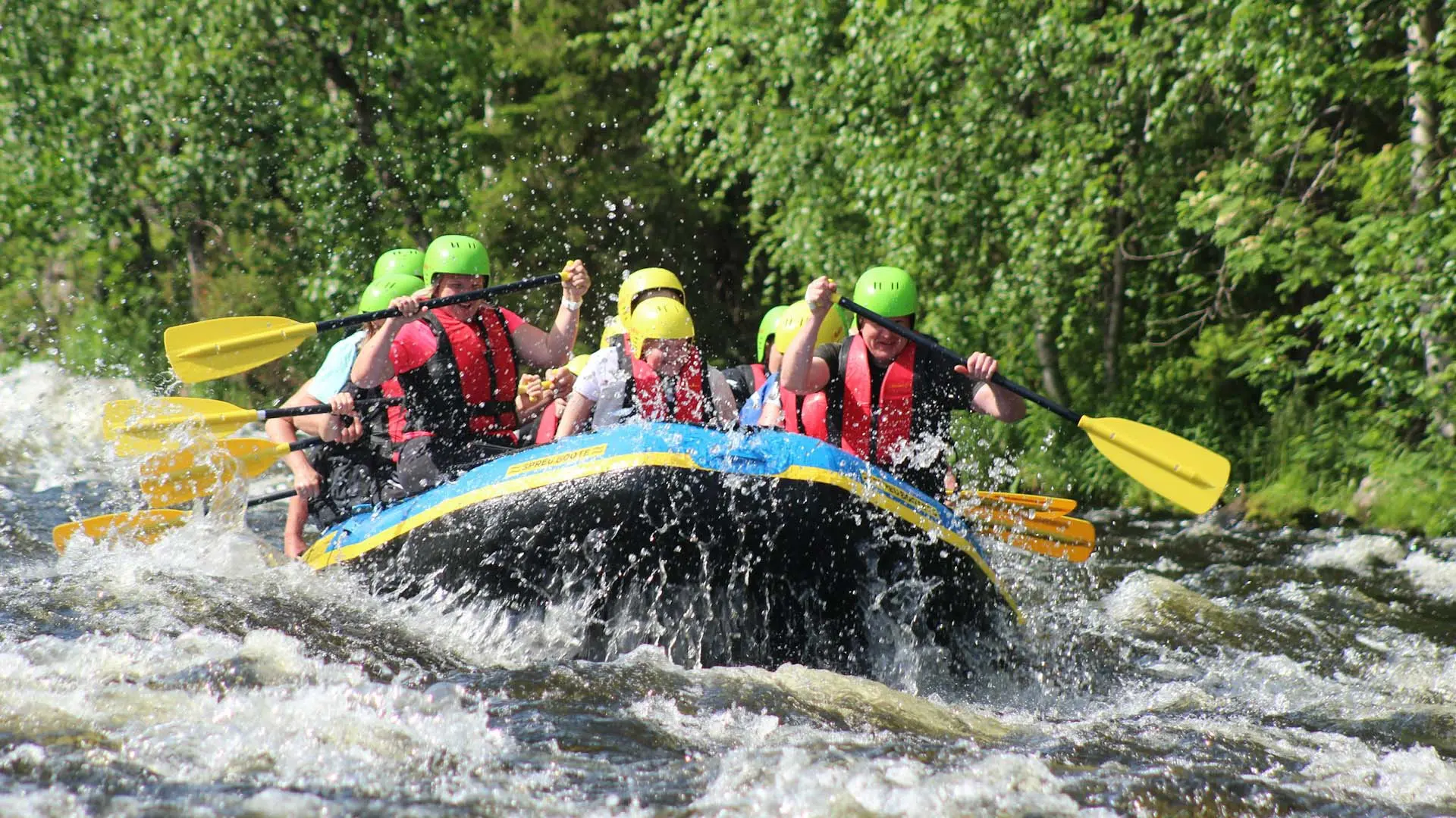 Exciting whitewater rafting at Kitulgala Adventure Camp, with a group paddling through rapids surrounded by lush greenery.