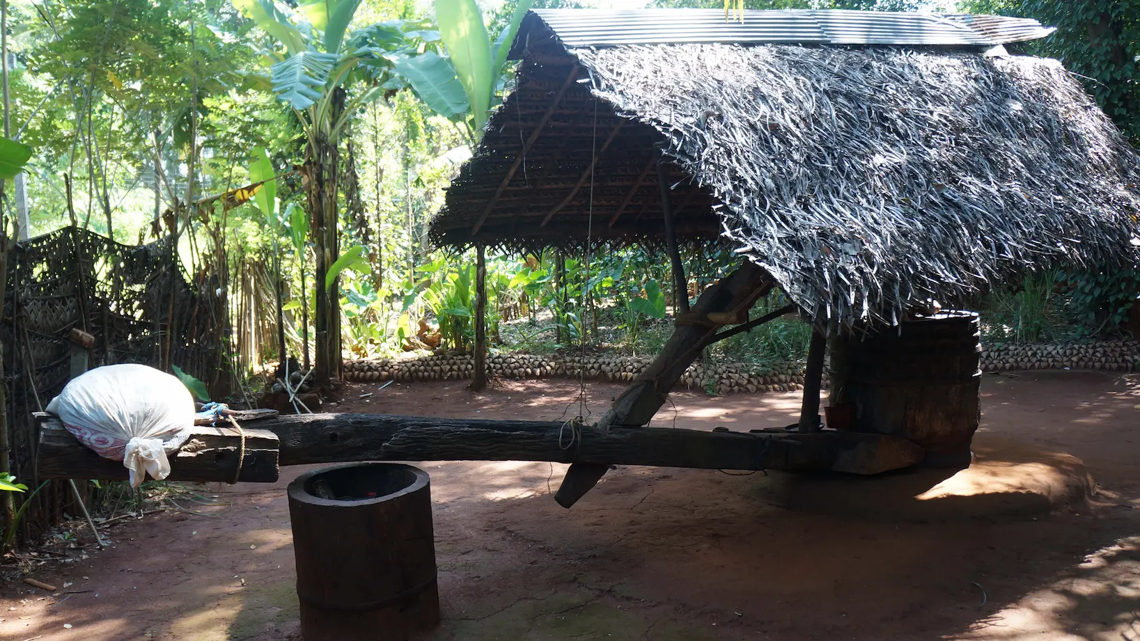 Traditional Moulin à huile at Matale Herbal and Spice Garden amidst lush greenery.